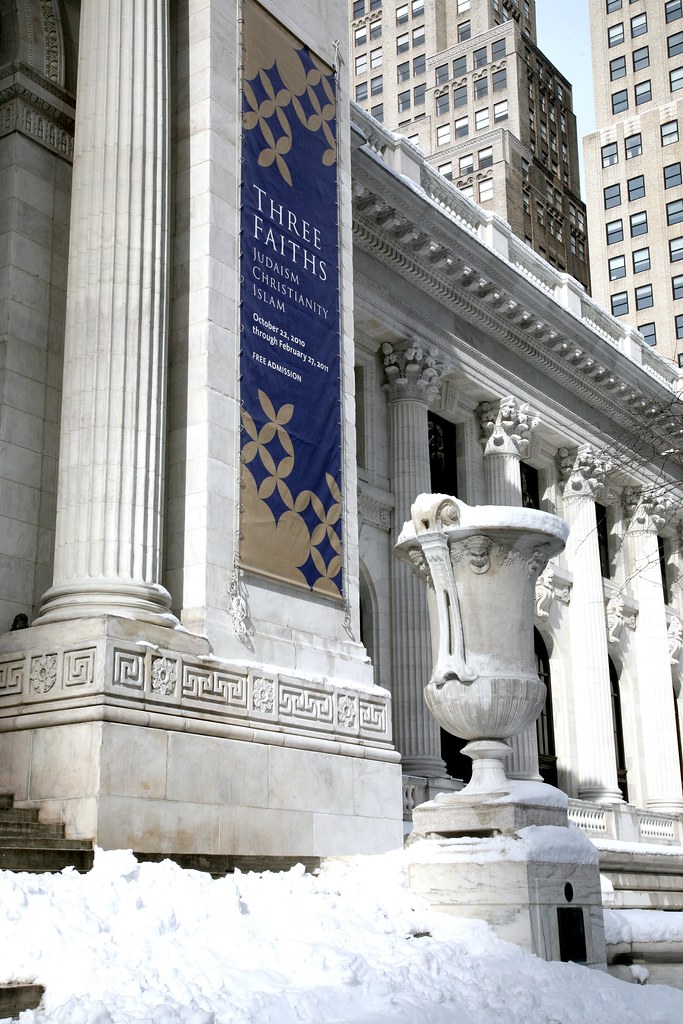 Marble courthouse columns against a dusky sky