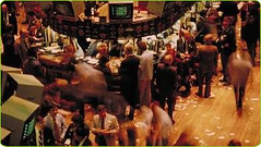 Financial district trading floor with stock ticker displays at dawn