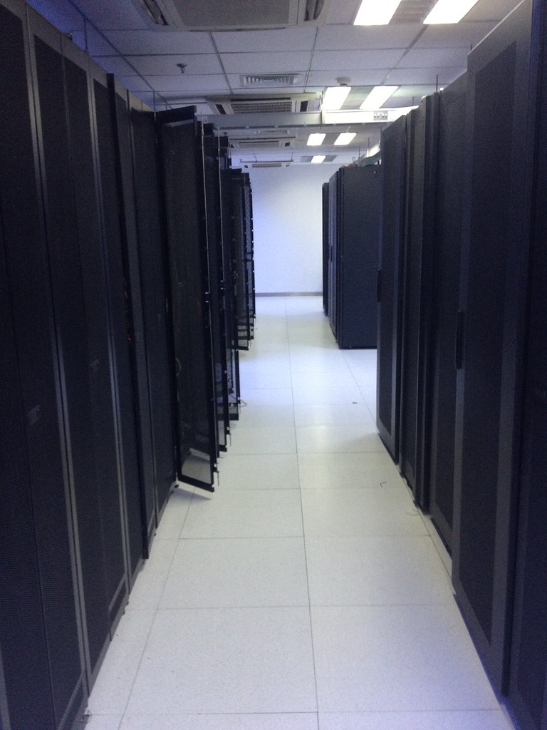Rows of illuminated server racks in a modern data center corridor